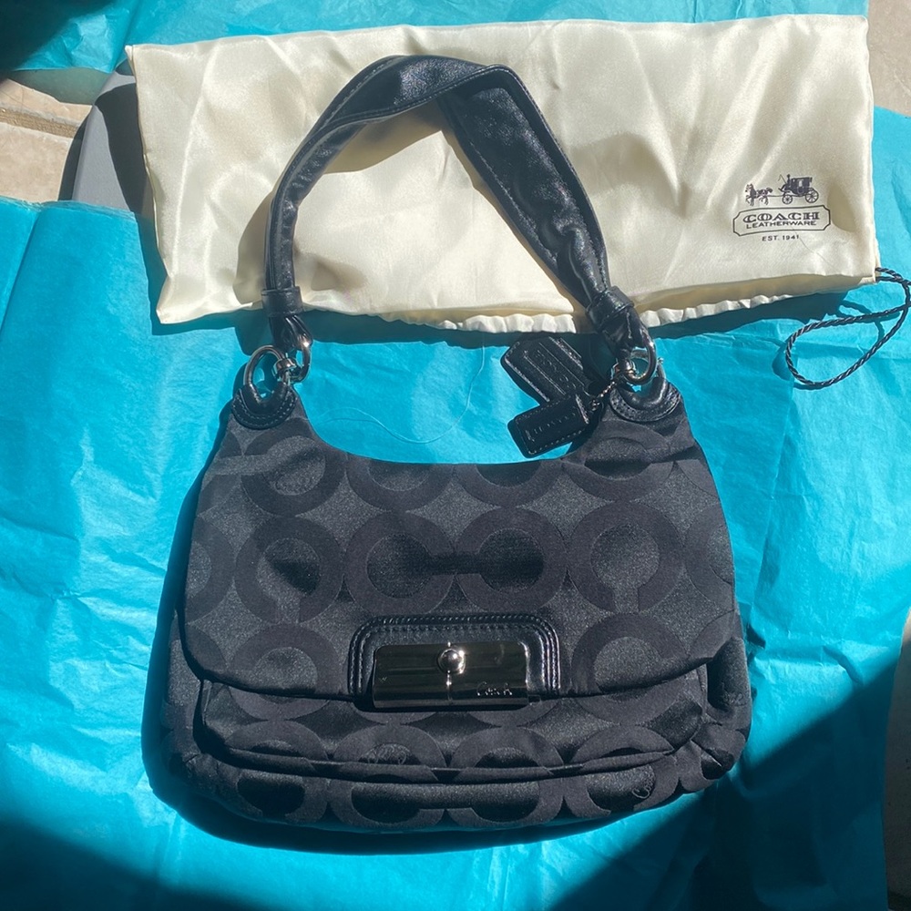 Coach bag in black along with a dust cover in its original box